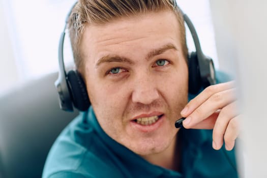 A detailed close-up captures a focused customer support representative wearing a headset while providing assistance in a call center setting.