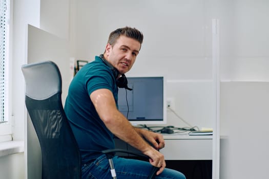 A detailed close-up captures a focused customer support representative wearing a headset while providing assistance in a call center setting.