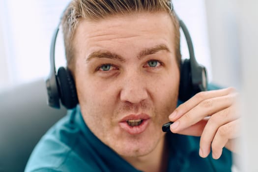 A detailed close-up captures a focused customer support representative wearing a headset while providing assistance in a call center setting.