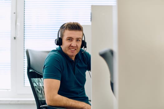 A detailed close-up captures a focused customer support representative wearing a headset while providing assistance in a call center setting.