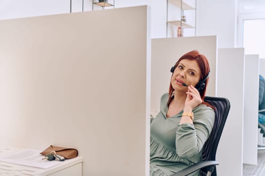 A female call center agent can be seen providing dedicated support and assistance to customers, aiding them in resolving various issues they encounter.