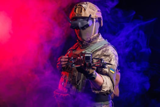 Soldier in gear holds drone against a red and blue smoky background, conveying intensity and military action