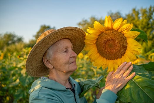 A woman in a straw hat is holding a sunflower. Concept of warmth and happiness, as the woman is surrounded by the bright and cheerful flower