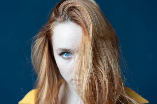 portrait of a young beautiful woman with red hair in the studio