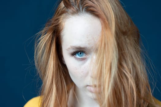 portrait of a young beautiful woman with red hair in the studio