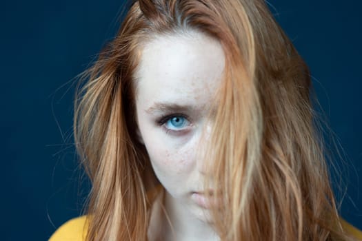 portrait of a young beautiful woman with red hair in the studio