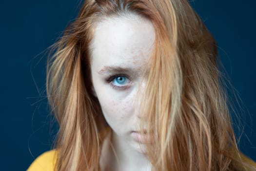 portrait of a young beautiful woman with red hair in the studio