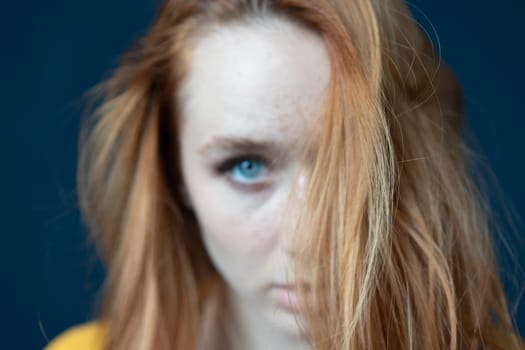 portrait of a young beautiful woman with red hair in the studio