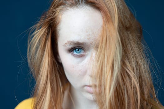 portrait of a young beautiful woman with red hair in the studio