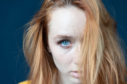 portrait of a young beautiful woman with red hair in the studio