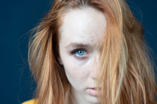 portrait of a young beautiful woman with red hair in the studio