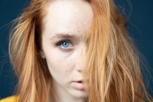 portrait of a young beautiful woman with red hair in the studio