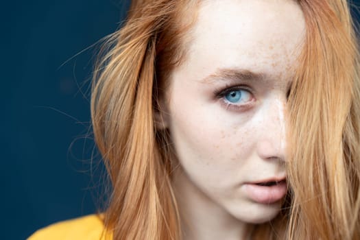 portrait of a young beautiful woman with red hair in the studio