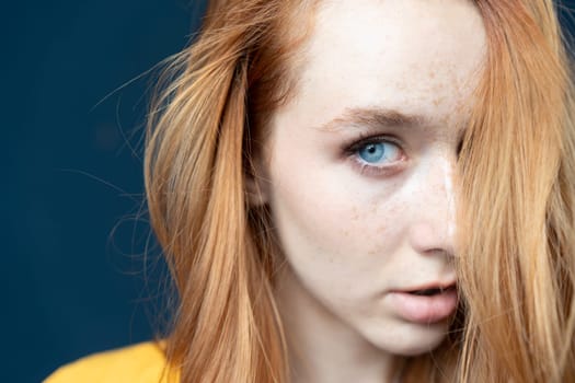 portrait of a young beautiful woman with red hair in the studio