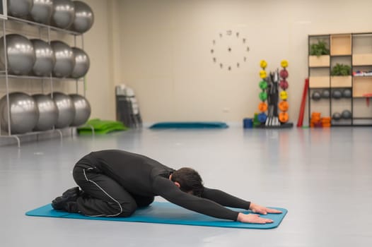 Caucasian man doing warm-up before exercise at a climbing wall