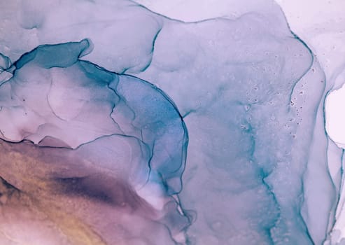 Closeup of abstract art made with ink and water, mainly blue and purple with hints of gold. The swirling patterns mesmerize with their uniqueness.