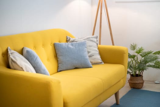 Interior design featuring a yellow couch in a living room industrial loft. High quality photo