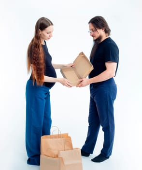 Portrait happy young pregnant woman and her husband with shopping bags and touching her big belly isolated on white background. Pregnancy shopping concept happy young family with shopping bags