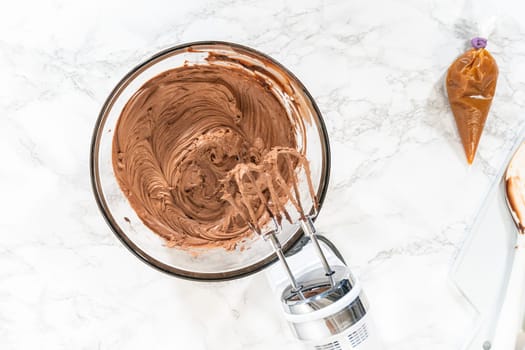 Flat lay. The frosting is whipped to perfection before being piped onto the delicious chocolate cupcakes.