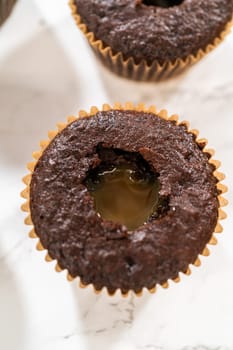 Each chocolate cupcake receives a generous filling of luscious caramel, adding an extra layer of flavor and indulgence.