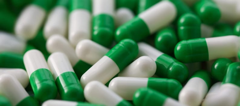 Large number of pharmaceutical white-green tablets. Production and development of new medicines concept