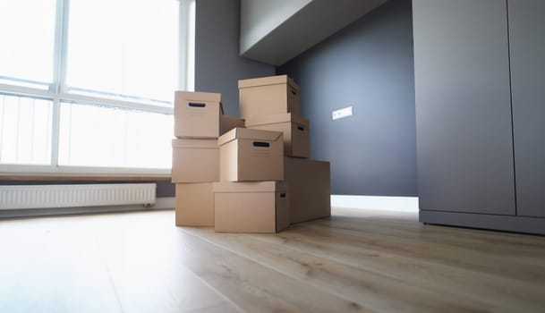 Large number of cardboard boxes are in room. Transport company services when moving concept