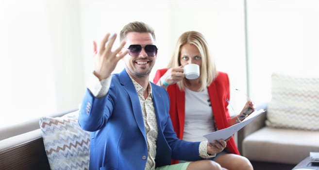 Businesswoman and businessman drink coffee in cafe discussing business projects. Business meeting partners concept