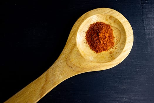 Red paprika powder.Zenithal image .Brochure for spices and asian or indian food promotions.Concept of spices and flavours. Space for text.