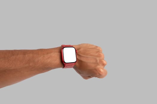 Male hand wearing a red smartwatch isolated no background blanc screen. High quality photo