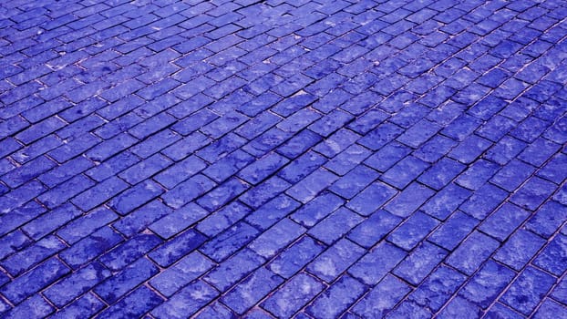 Fragment of an old square with blue paving stones. .Old, vintage, decorative paving stones.