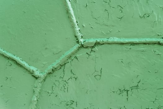 Green metal surface with a weld seam. Grunge metal texture. Green grunge metal textured wall background.