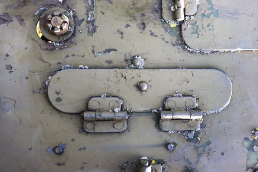 Detail of an old military armored vehicle with a door lock.