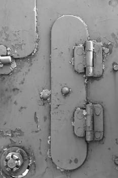 Metal texture with rivets and bolts. Black and white photo.