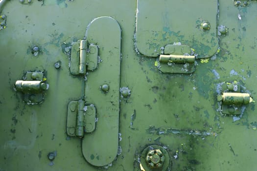 Close-up of an old green military armored tank with rivets