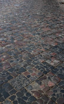 Abstract background of old cobblestone pavement close-up.