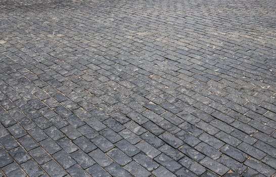 Old cobblestone pavement. Abstract background. Old cobblestone pavement close-up.