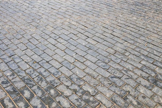 Texture. Abstract background. Old cobblestone pavement close-up.