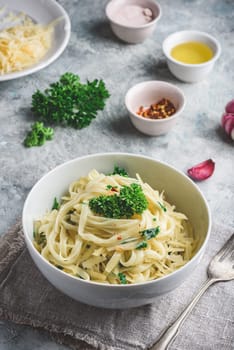 Easy lunch recipe. Linguine pasta with olive oil, garlic, fresh parsley and grated parmesan cheese.