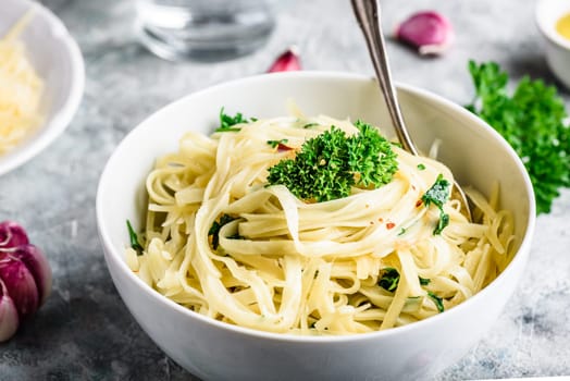 Easy lunch recipe. Linguine pasta with olive oil, garlic, fresh parsley and grated parmesan cheese.