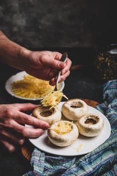 Stuffing button mushrooms with grated cheddar cheese