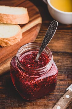 Jar of homemade raspberry jam. Toasts for breakfast.