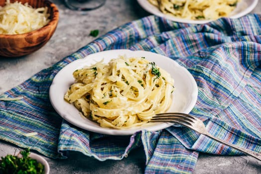 Portions of Homemade Pasta with Alfredo Sauce