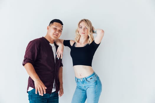 man and a woman couple stand in a bright room