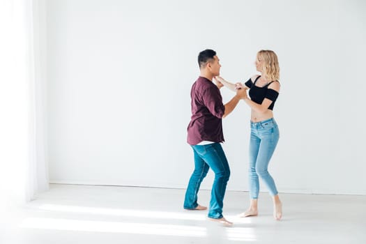 a man and a woman dance bachata latin casombu salta in the studio hall