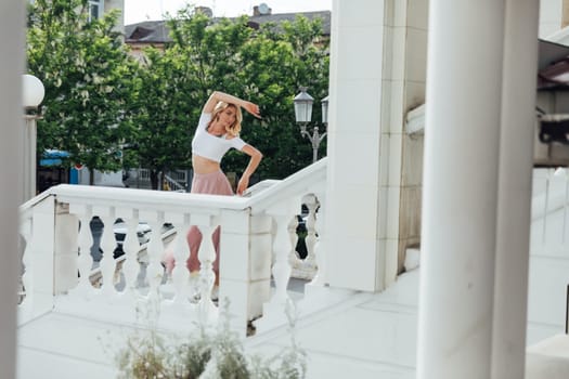 woman dancing on the stairs on the street alone