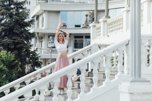 woman dancing on the stairs on the street alone