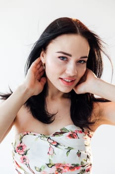 portrait of cheerful brunette woman on a light background