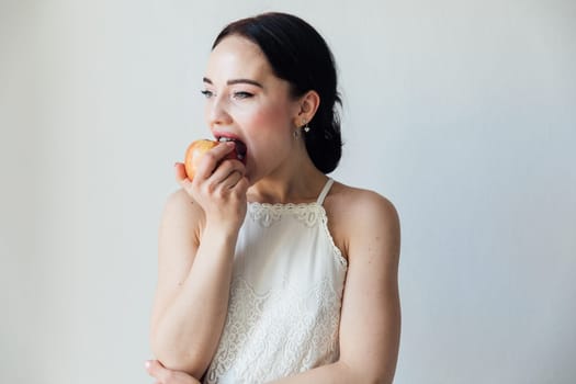 a woman bites ripe apple healthy nutrition food vitamins