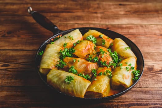 Frying Pan Full of Cabbage Rolls Stuffed with Minced Beef Served with Chopped Parsley