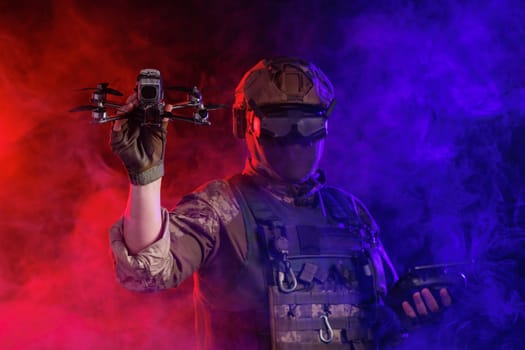 Soldier in gear holds drone against a red and blue smoky background, conveying intensity and military action